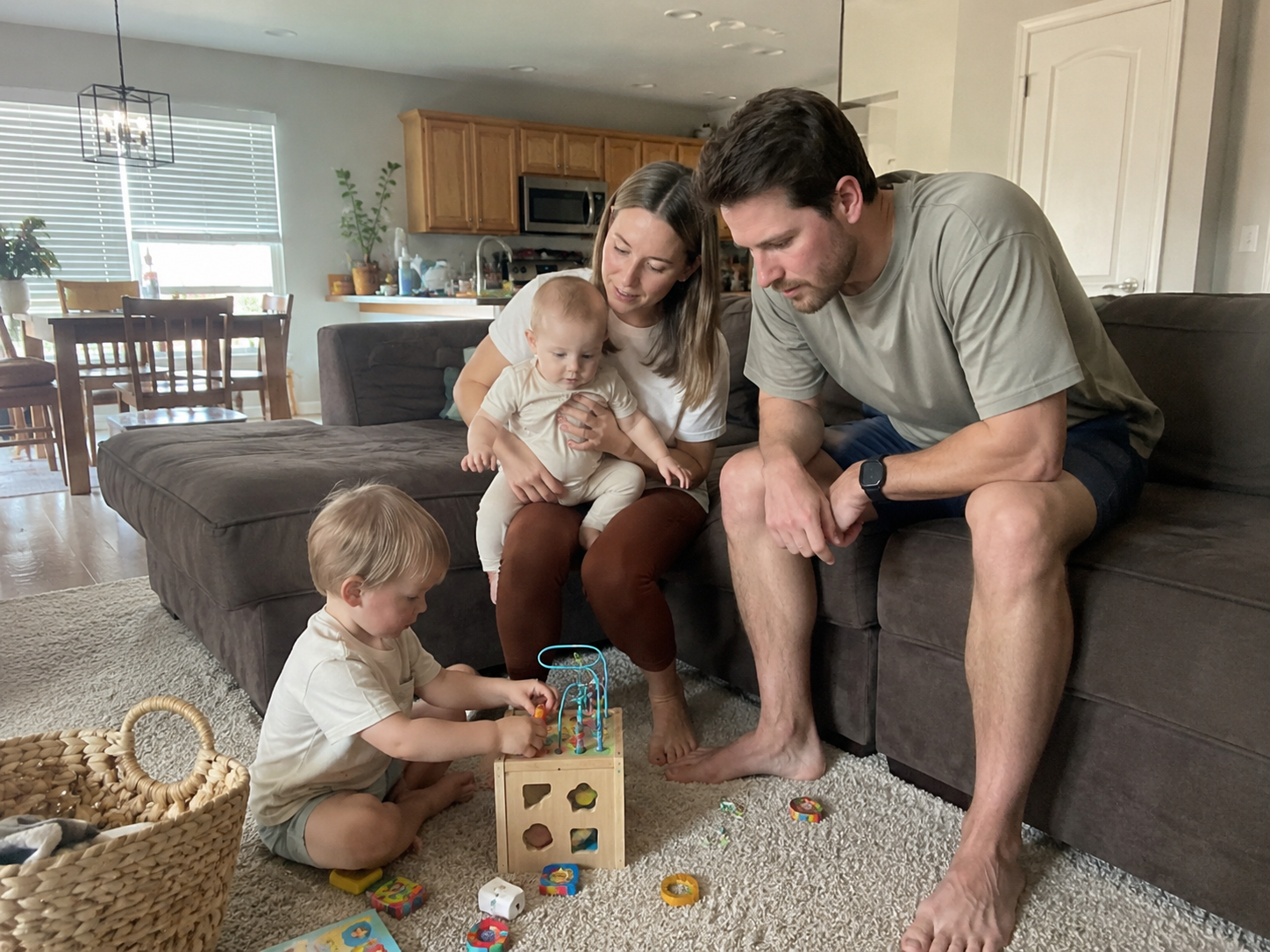 A raw candid iPhone photo of a young family of four showing a mother married to an indifferent husband