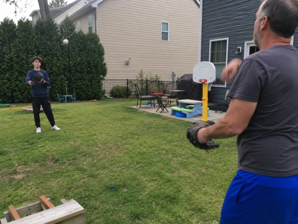 Father and teenage son playing baseball while parenting a rebellious teenager