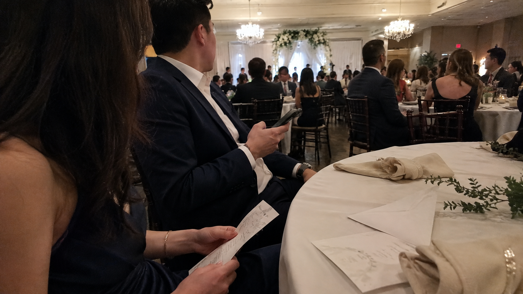 Couple attending a wedding while discussing wealthy boyfriend support